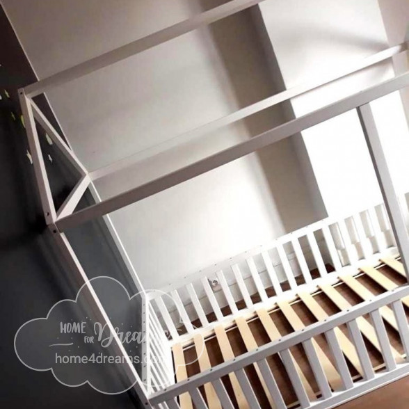 A toddler house bed frame with rails