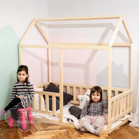 Children posing next to a toddler floor bed