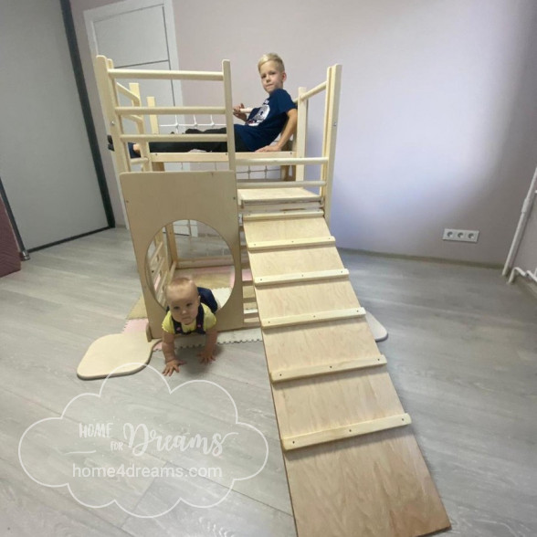 A square play gym for toddlers with an additional climbing board