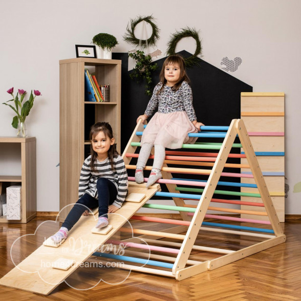 Children sitting on a triangle climber toy with a rock board