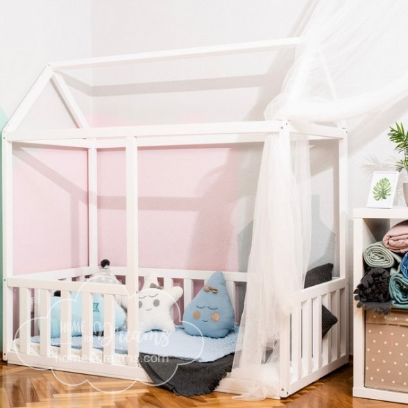 A house bed with rails, decorated with soft toys