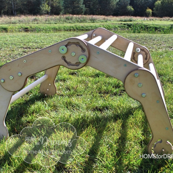 Wooden climbing toy for toddlers on a lawn