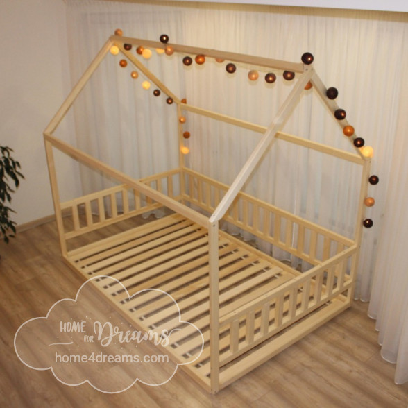 A toddler floor bed frame decorated with a lighting chain