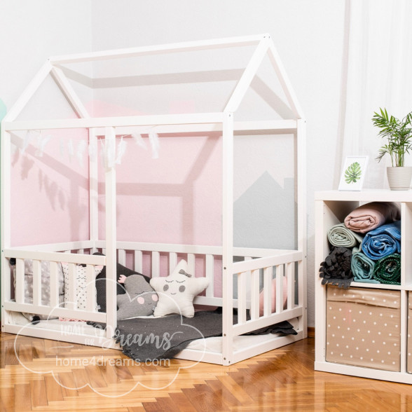 A woodend toddler bed with toys and pillows